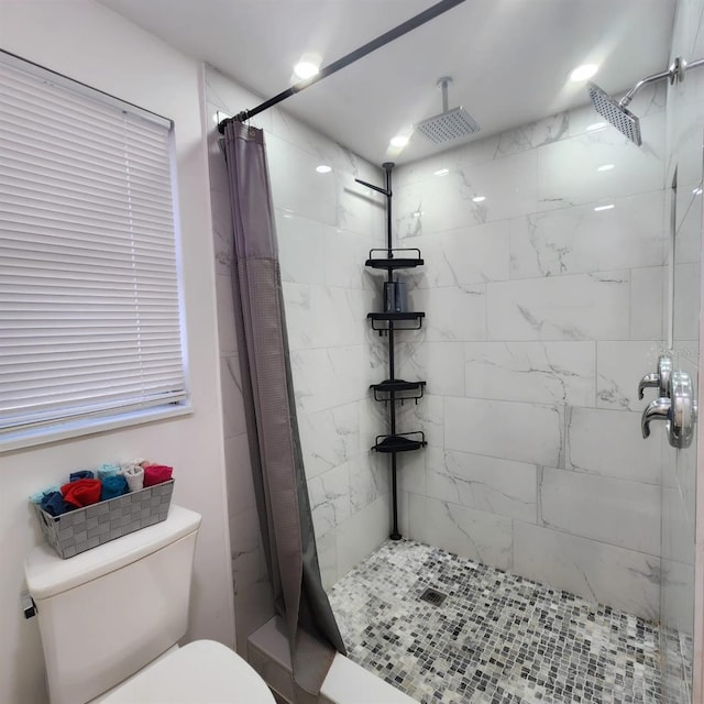 bathroom featuring toilet and a shower with shower curtain