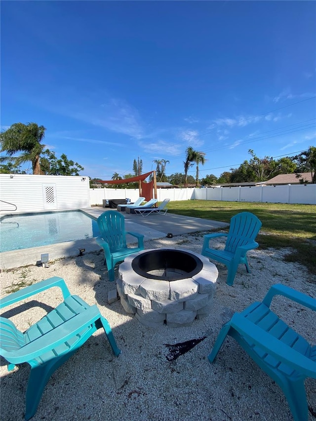 view of yard with a fenced in pool, a patio, and a fire pit