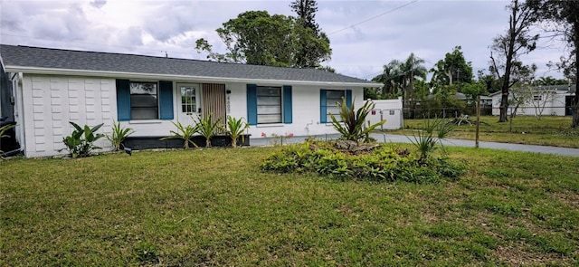 ranch-style home with a front yard and covered porch