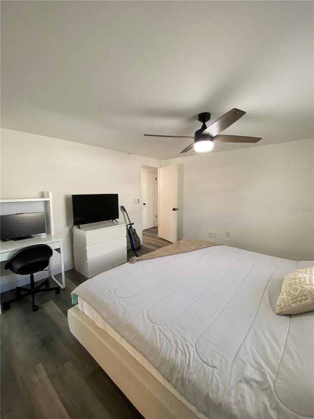 bedroom with ceiling fan and dark hardwood / wood-style floors