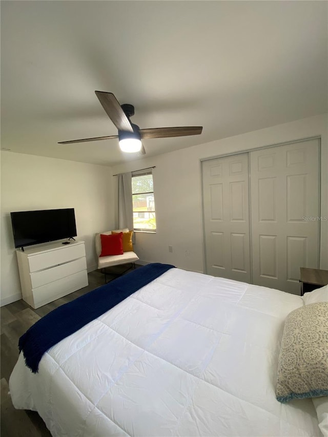 bedroom featuring hardwood / wood-style flooring, ceiling fan, and a closet