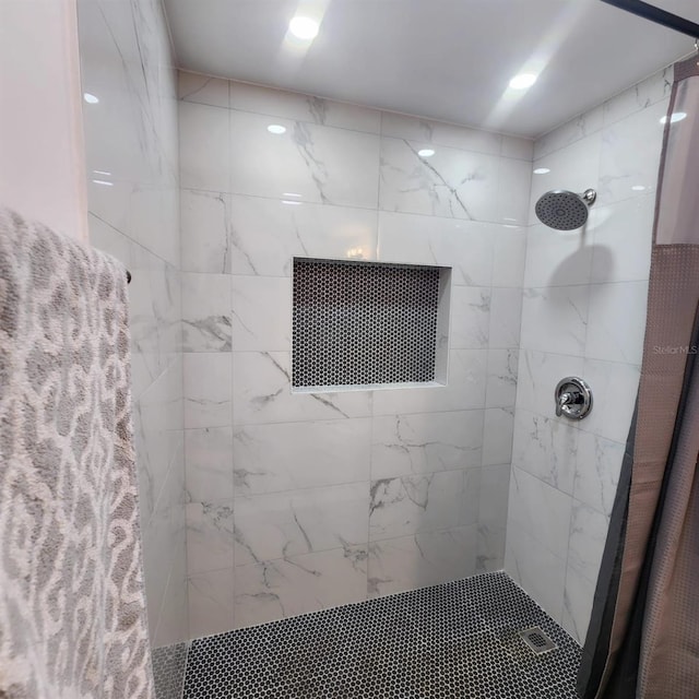 bathroom with tiled shower