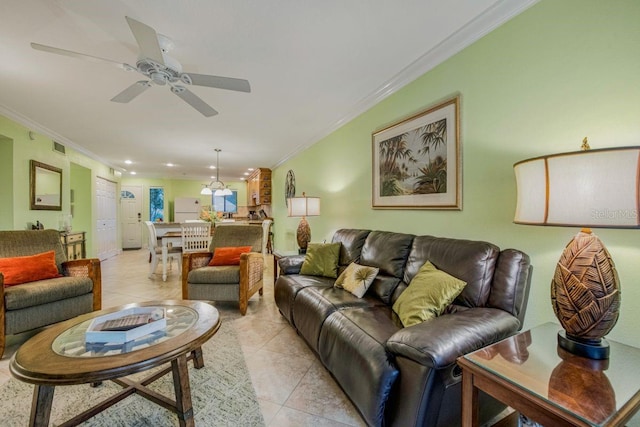 living room with ornamental molding, visible vents, ceiling fan, and light tile patterned floors