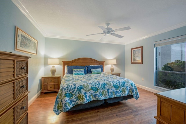 bedroom featuring ornamental molding, wood finished floors, and baseboards