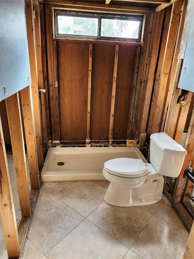 bathroom with toilet and tile patterned flooring