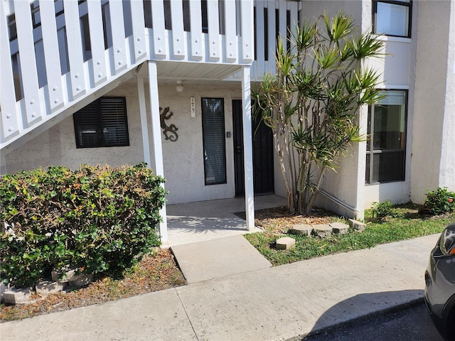 entrance to property featuring stucco siding