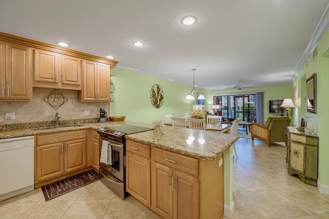 kitchen featuring dishwasher, a peninsula, a sink, and stainless steel electric stove