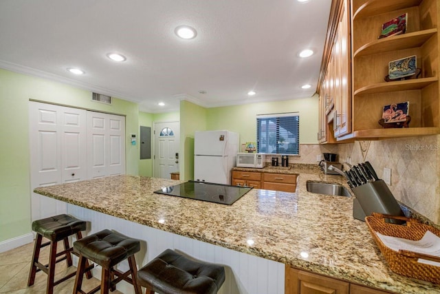 kitchen with open shelves, visible vents, a sink, white appliances, and a peninsula