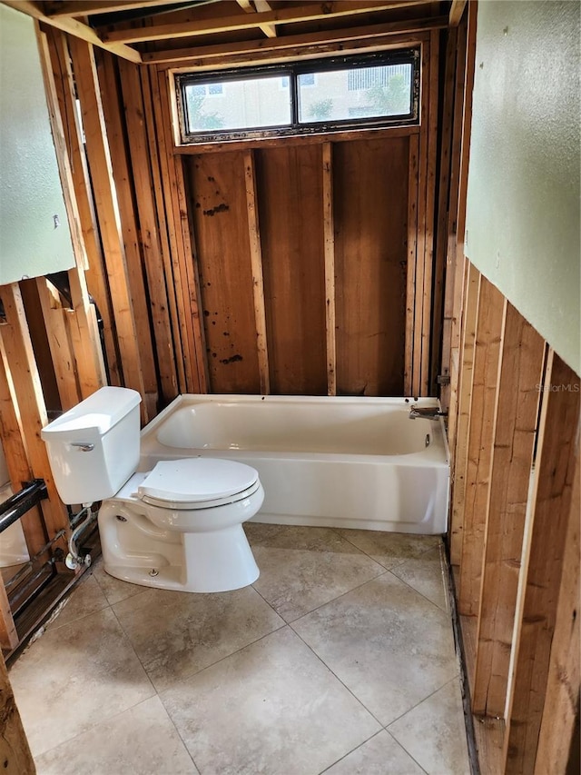 full bath with toilet, a healthy amount of sunlight, and a bathtub