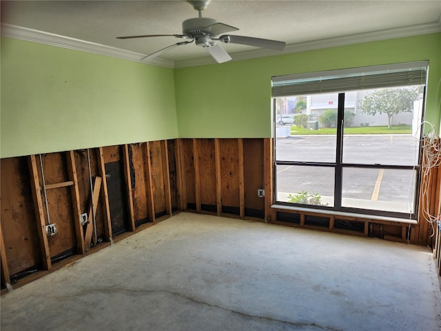 empty room with ornamental molding, unfinished concrete flooring, and a ceiling fan