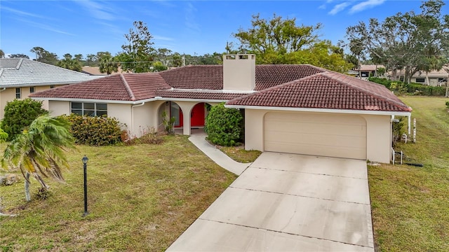 mediterranean / spanish-style home featuring a garage and a front lawn