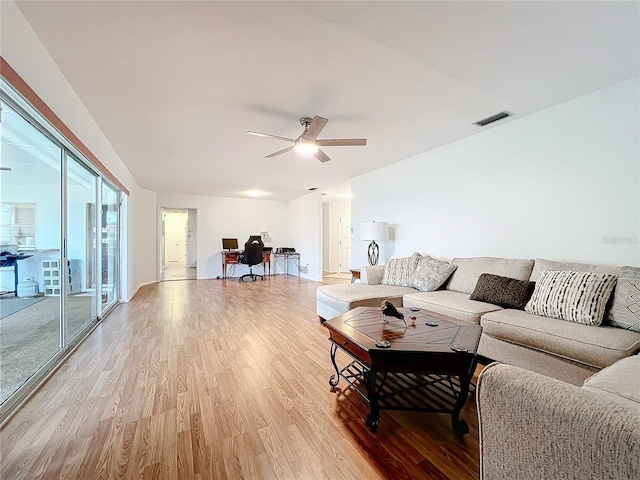 living room featuring ceiling fan and light hardwood / wood-style floors