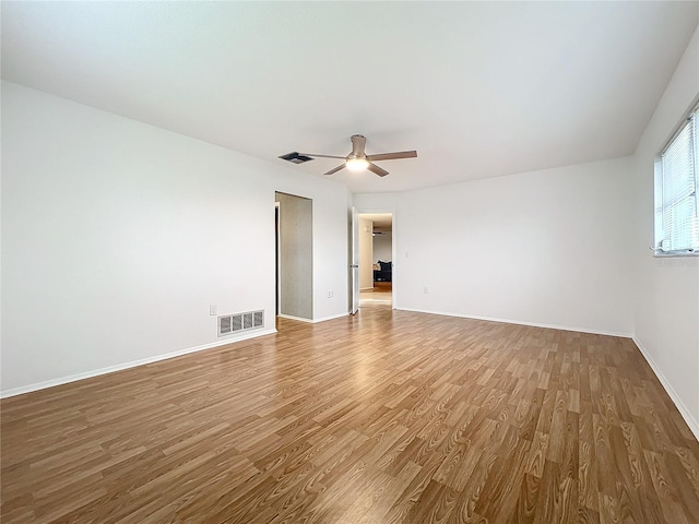 spare room with ceiling fan and wood-type flooring