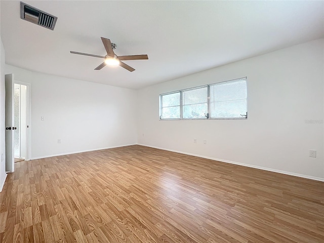 unfurnished room with hardwood / wood-style floors and ceiling fan