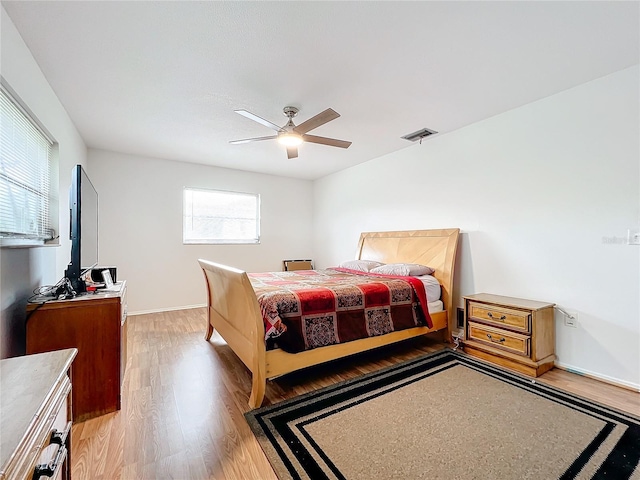 bedroom with ceiling fan and light wood-type flooring