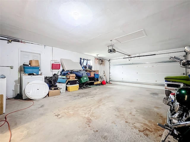 garage with washer and dryer and a garage door opener