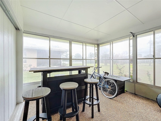 sunroom featuring a paneled ceiling