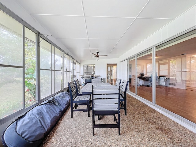 sunroom / solarium featuring ceiling fan