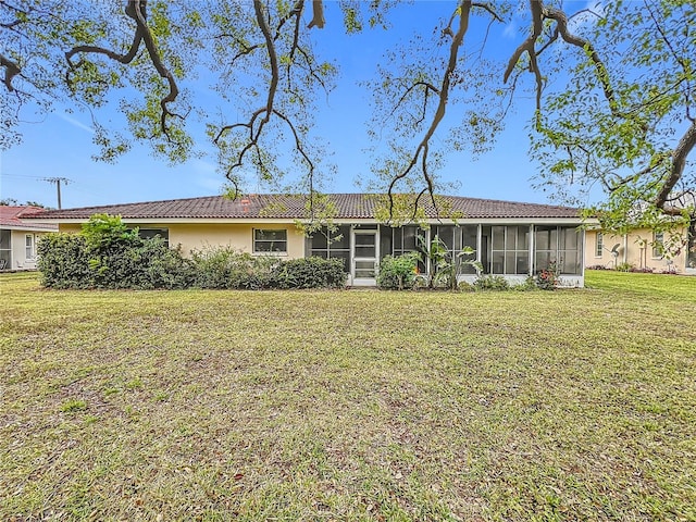 view of front of property featuring a sunroom and a front yard