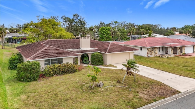 mediterranean / spanish-style house featuring a garage and a front yard