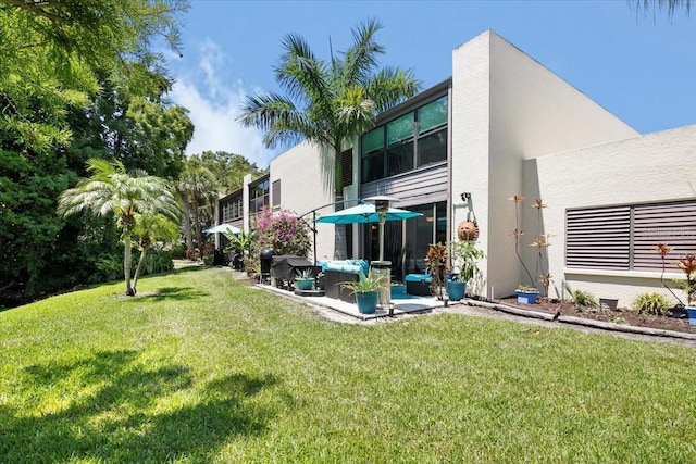 exterior space with an outdoor living space, a yard, and a patio area