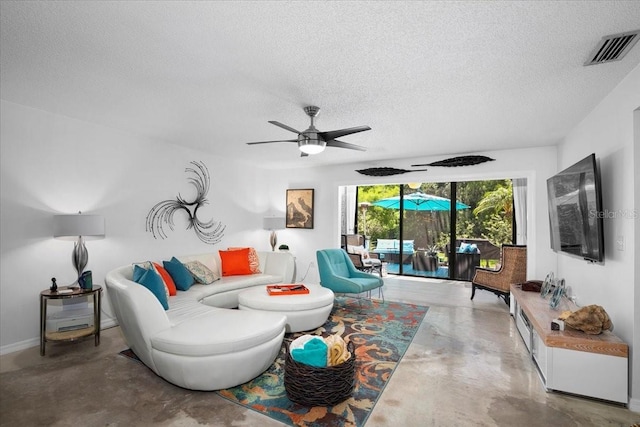 living room featuring ceiling fan, concrete floors, and a textured ceiling