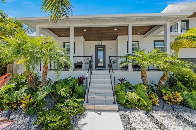 view of exterior entry featuring a porch