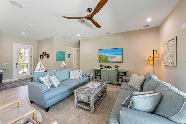 living room featuring light wood-type flooring and ceiling fan