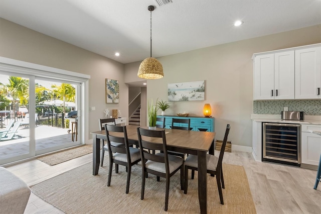 dining area featuring light hardwood / wood-style floors and beverage cooler