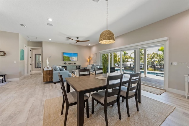 dining room with ceiling fan and light hardwood / wood-style floors