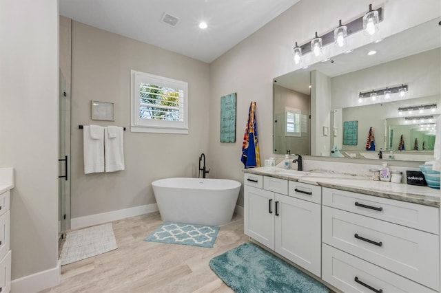 bathroom featuring vanity, wood-type flooring, and independent shower and bath