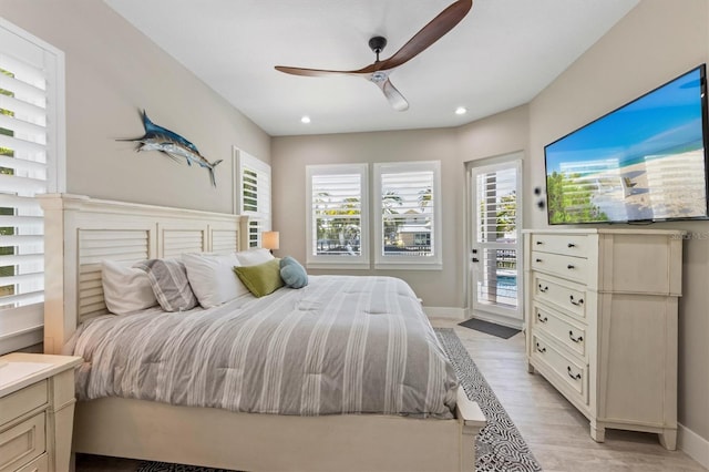 bedroom featuring ceiling fan, light wood-type flooring, and access to outside