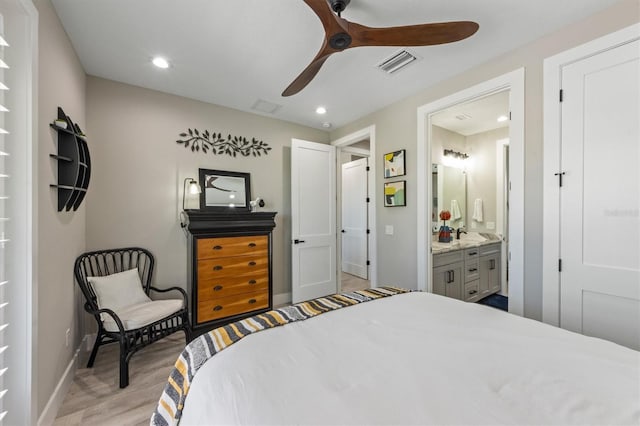 bedroom featuring ensuite bath, ceiling fan, and light hardwood / wood-style floors