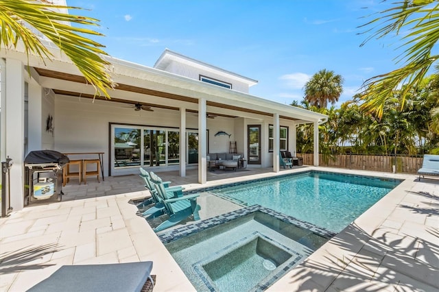 view of swimming pool with an in ground hot tub, ceiling fan, and a patio