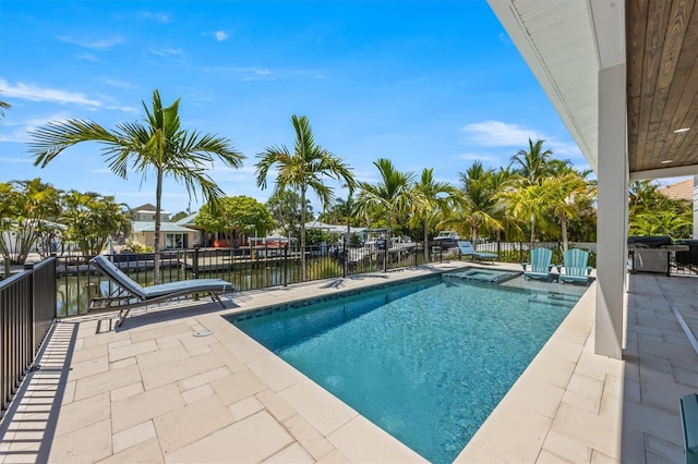 view of pool featuring a patio area and a water view