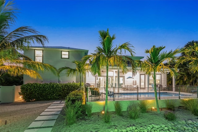 exterior space featuring a fenced in pool and a patio