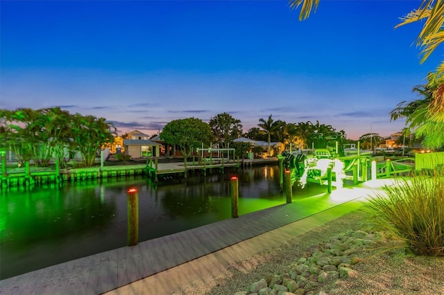 surrounding community with a water view and a boat dock