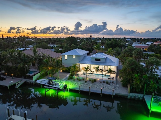 aerial view at dusk with a water view