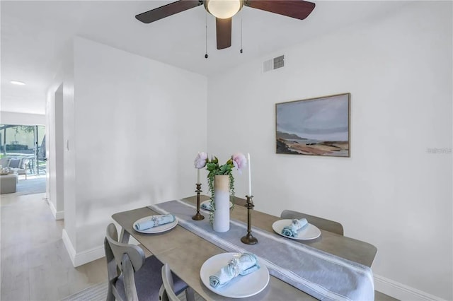 dining space featuring ceiling fan and light hardwood / wood-style flooring