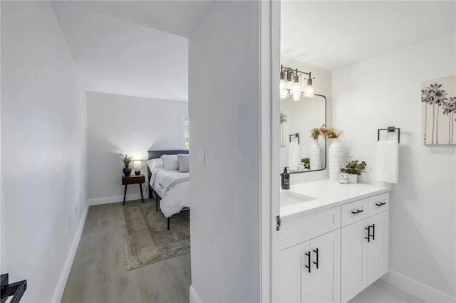 bathroom with vanity and hardwood / wood-style flooring