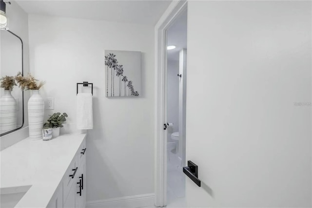 bathroom featuring vanity and toilet