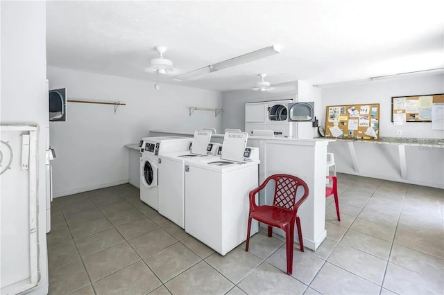 laundry room featuring ceiling fan, light tile patterned floors, washer and dryer, and stacked washer and clothes dryer