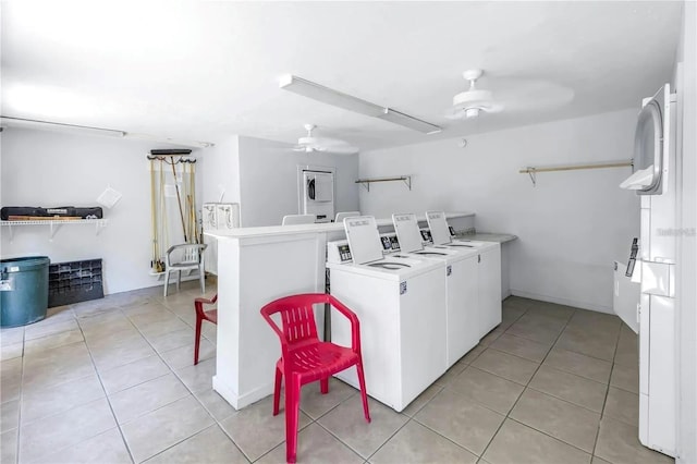 laundry area with washer and clothes dryer, ceiling fan, and light tile patterned floors