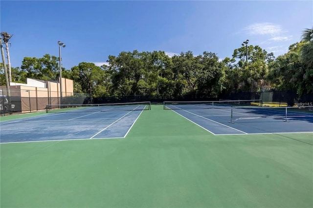 view of tennis court with basketball hoop