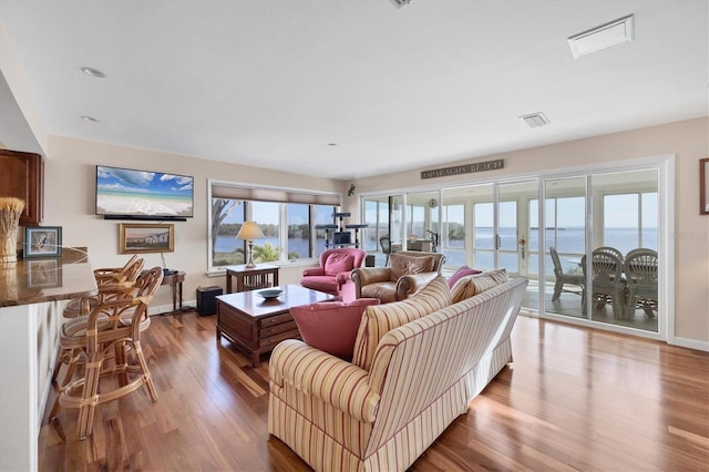 living room featuring french doors and hardwood / wood-style flooring