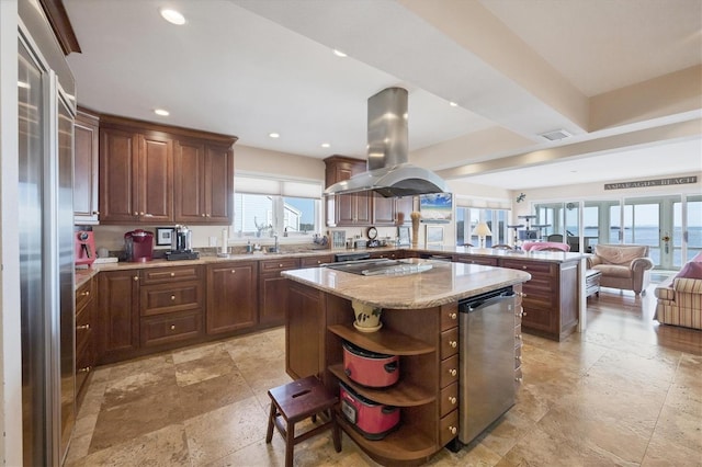 kitchen featuring a center island, a water view, appliances with stainless steel finishes, island range hood, and kitchen peninsula