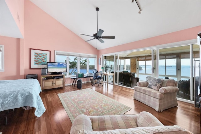 bedroom with access to exterior, ceiling fan, hardwood / wood-style floors, and rail lighting