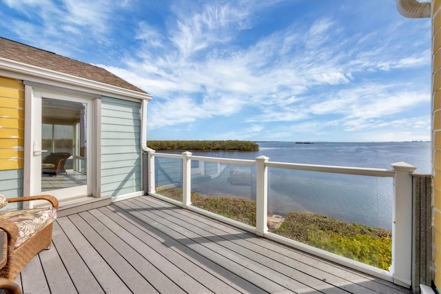 wooden deck featuring a water view