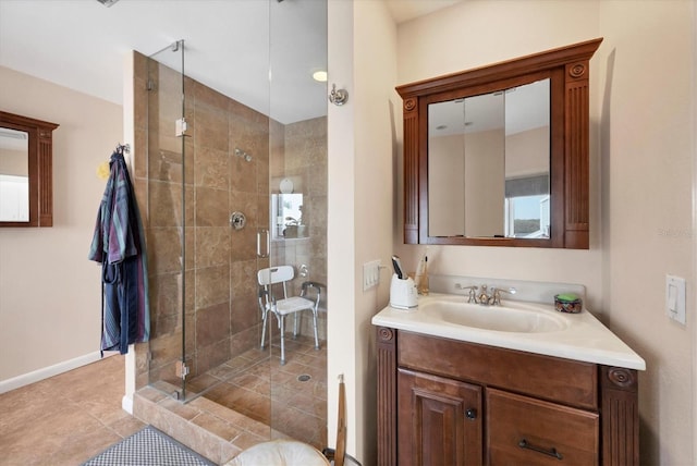 bathroom featuring a shower with door, vanity, and tile patterned flooring