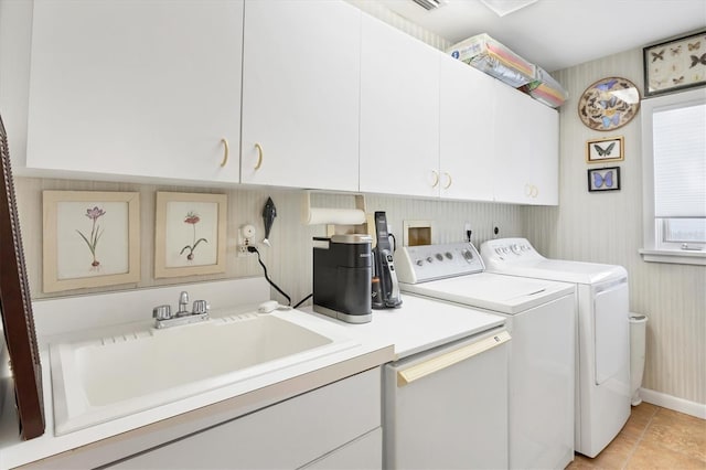 laundry room with light tile patterned flooring, cabinets, independent washer and dryer, and sink